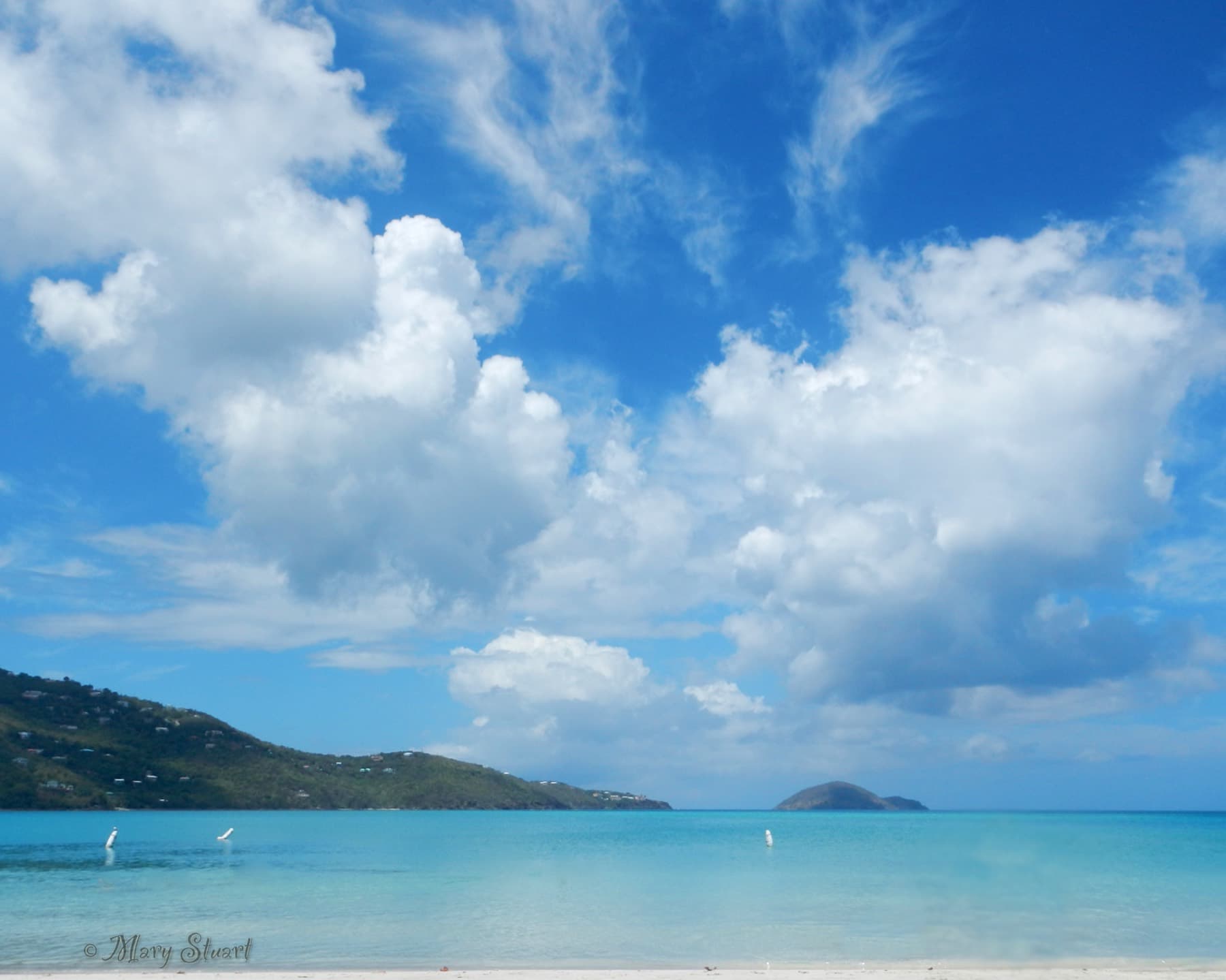 Blue water and green hills at Magens Bay