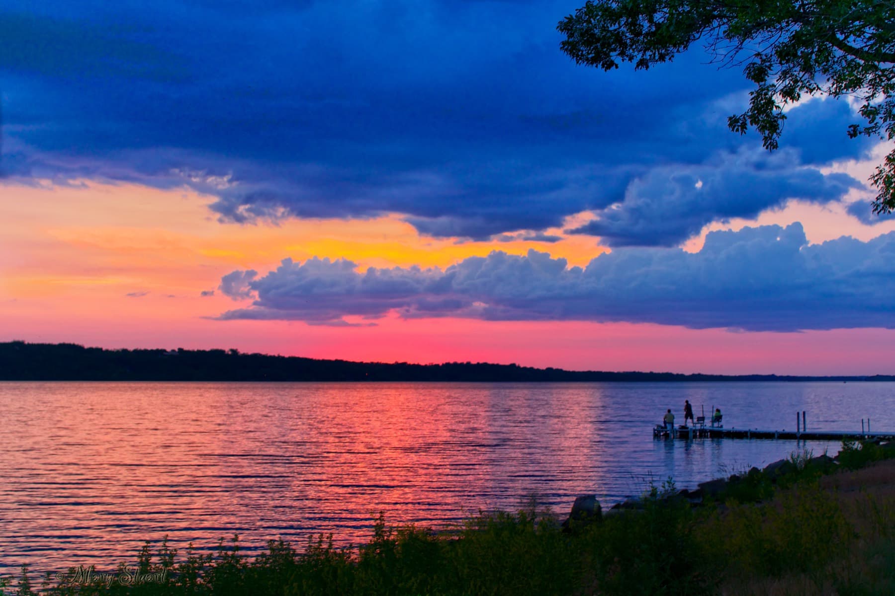 A vivid pink, orange, and blue sunset over Big Stone Lake